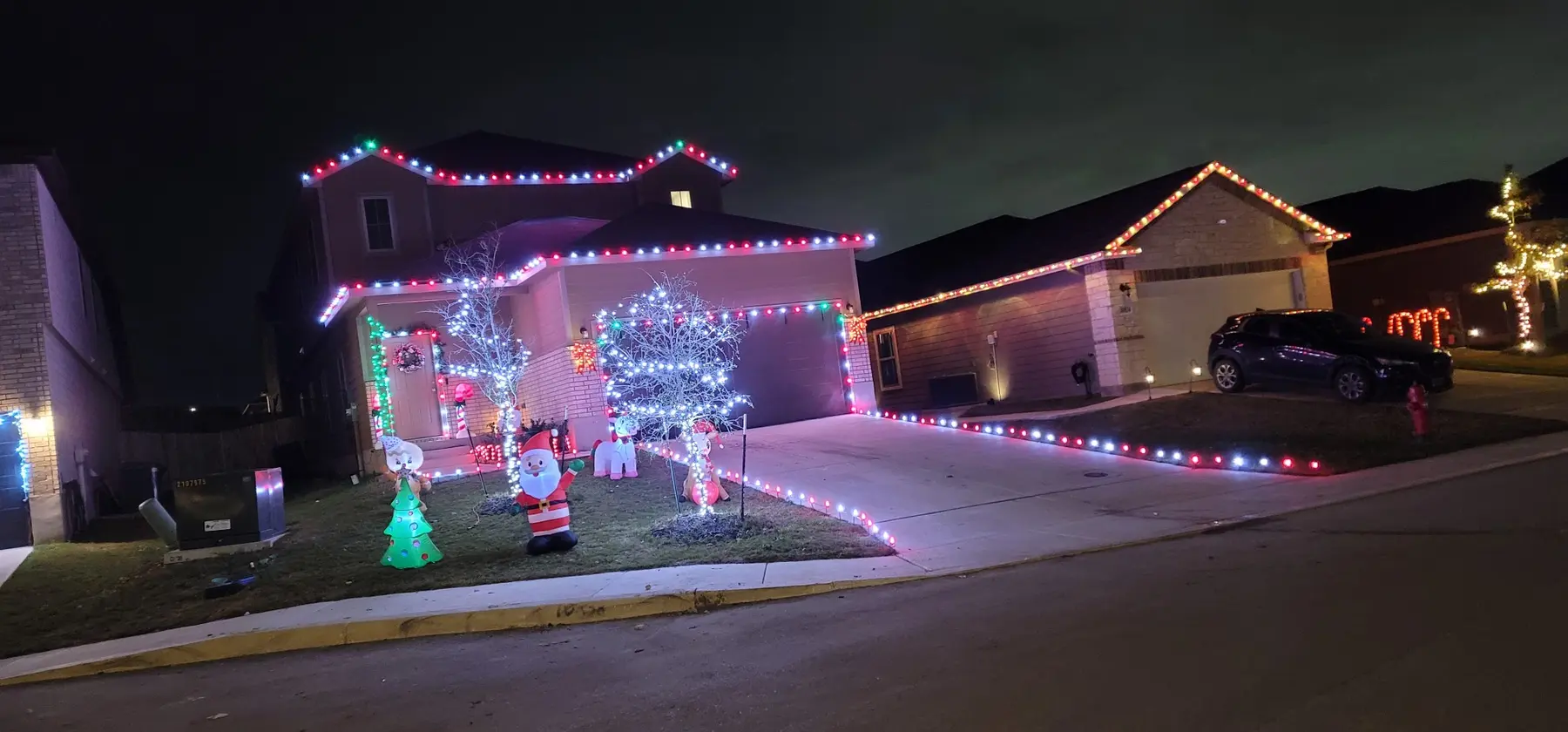 Colorful red, green and white residential holiday light installation